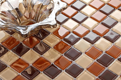 Close-up of a glass mosaic tile with brown and beige colors.